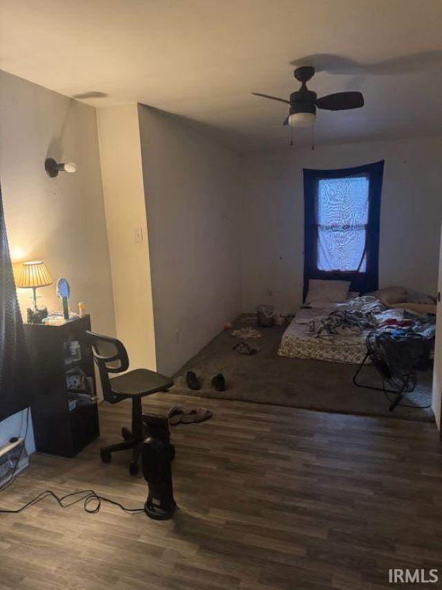 bedroom with wood-type flooring and ceiling fan