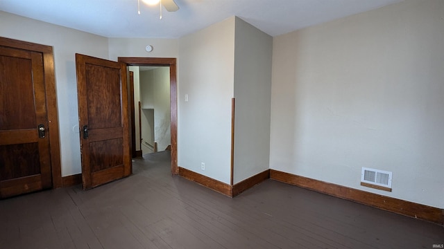 unfurnished bedroom with ceiling fan and dark hardwood / wood-style flooring