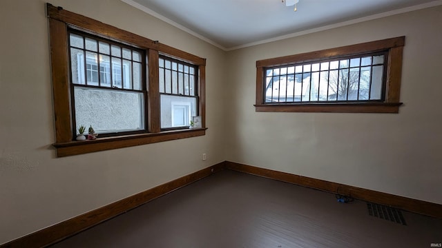 unfurnished room featuring crown molding