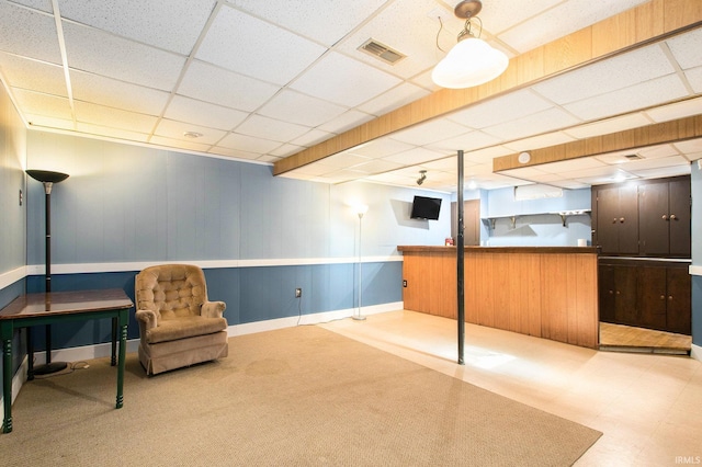 living area with a paneled ceiling