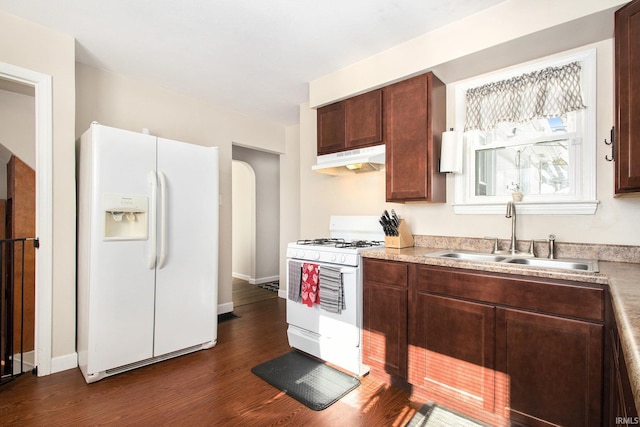 kitchen with sink, white appliances, and dark wood-type flooring