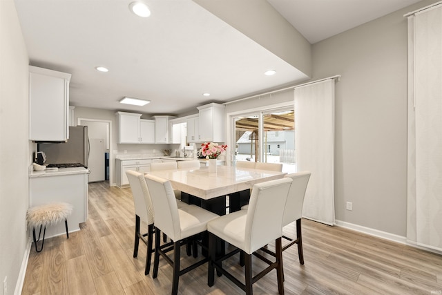 dining room with light hardwood / wood-style floors and sink