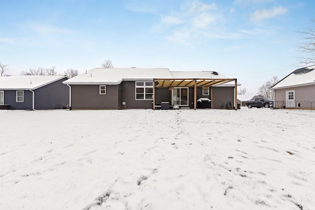 view of snow covered back of property