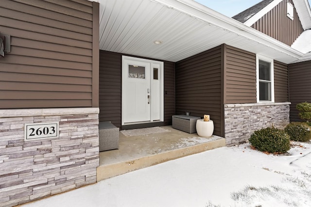 view of snow covered property entrance