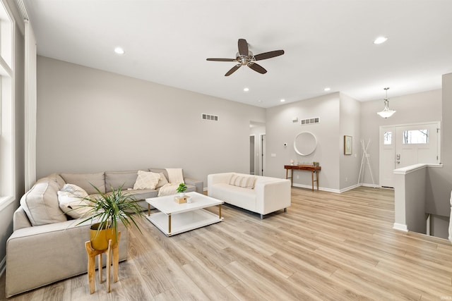 living room with ceiling fan and light hardwood / wood-style flooring