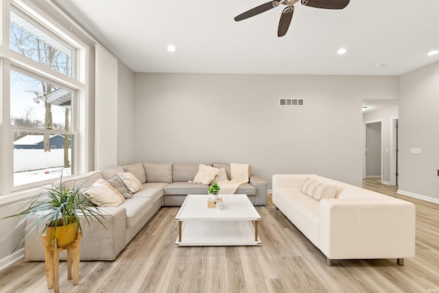 living room featuring ceiling fan and light wood-type flooring