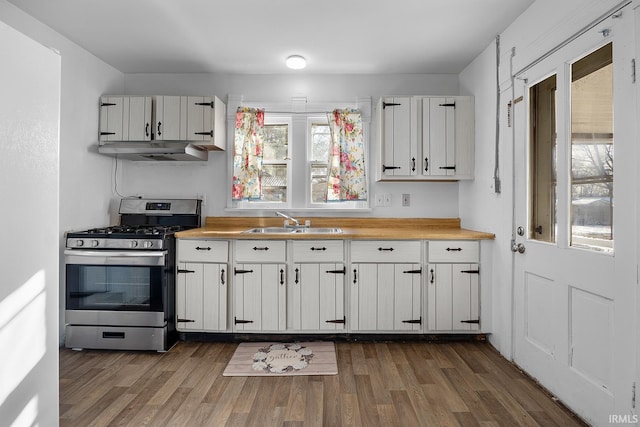 kitchen featuring gas range, sink, white cabinetry, and dark wood-type flooring