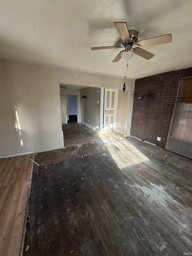 unfurnished room featuring ceiling fan, a baseboard radiator, and dark hardwood / wood-style floors