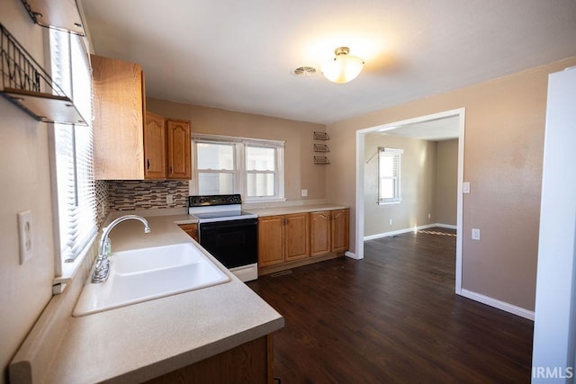 kitchen with sink, backsplash, dark hardwood / wood-style flooring, and electric stove