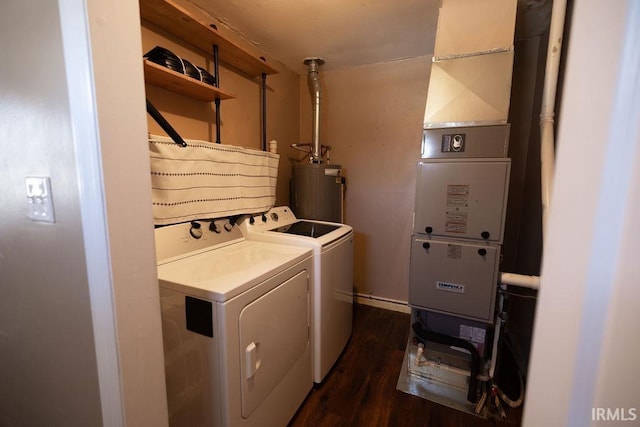 washroom featuring dark hardwood / wood-style flooring, gas water heater, and washing machine and clothes dryer