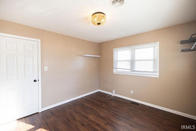 unfurnished room featuring dark hardwood / wood-style floors