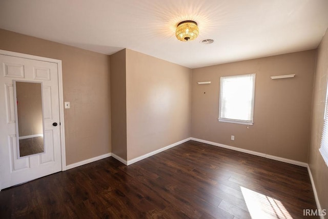 empty room featuring dark wood-type flooring