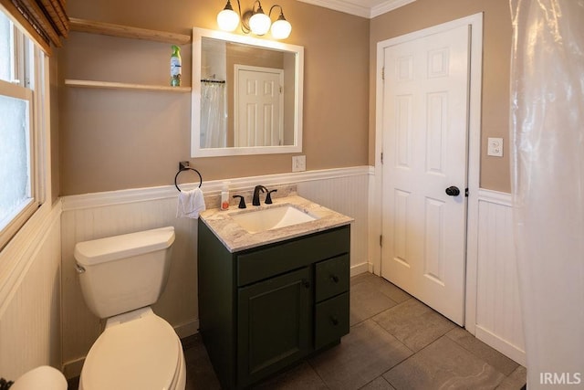 bathroom with tile patterned floors, vanity, an inviting chandelier, toilet, and ornamental molding