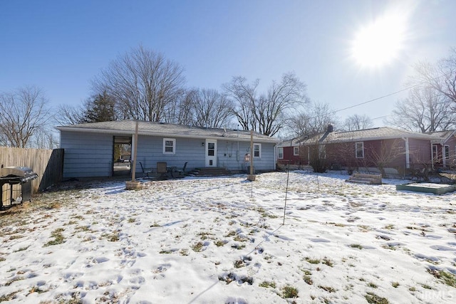 view of snow covered rear of property