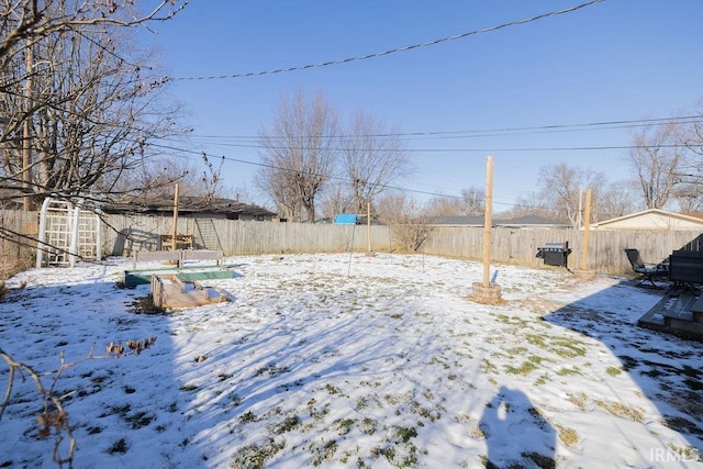 yard covered in snow featuring a storage shed