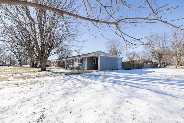 view of snow covered rear of property