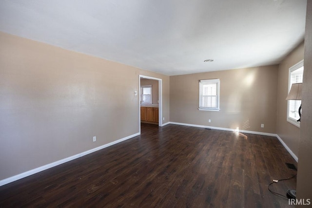 empty room with dark hardwood / wood-style floors