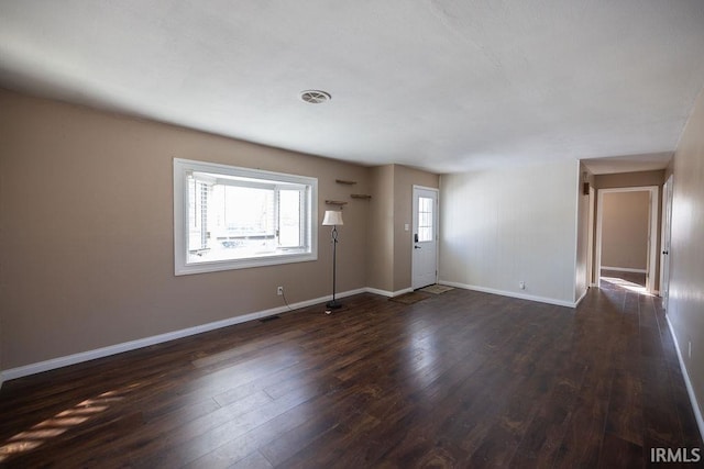 spare room with dark hardwood / wood-style flooring