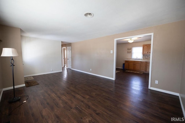 unfurnished living room with dark hardwood / wood-style floors