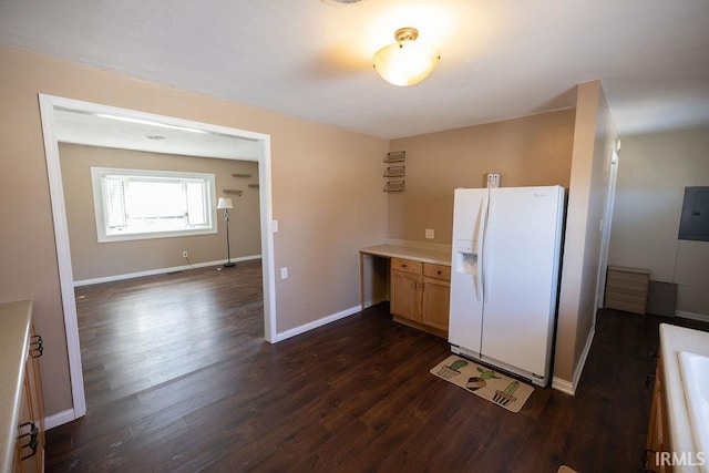 kitchen with dark wood-type flooring, white refrigerator with ice dispenser, and electric panel