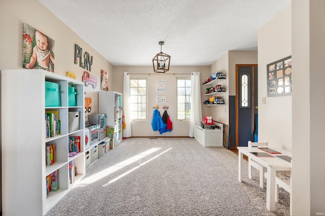 recreation room with a textured ceiling and carpet