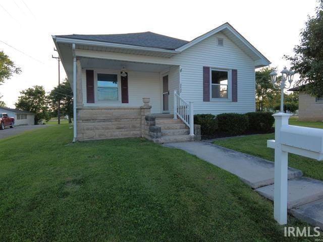 view of front facade with a front yard and a porch