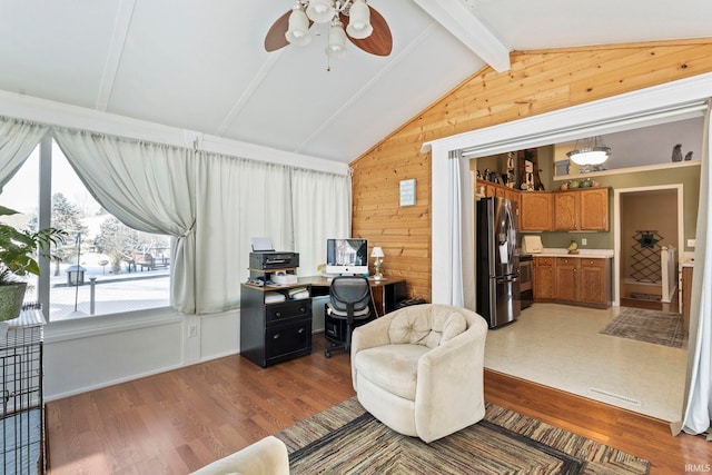 office with ceiling fan, vaulted ceiling with beams, dark wood-type flooring, and wooden walls