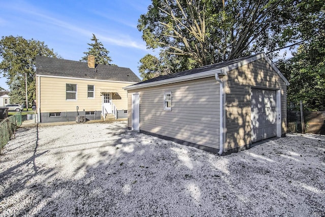 rear view of house with a garage and an outdoor structure