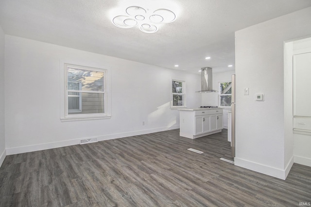 unfurnished living room featuring dark hardwood / wood-style floors and a textured ceiling