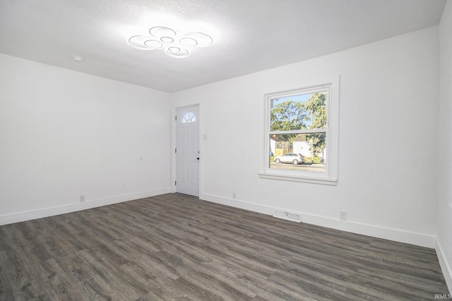 spare room with dark hardwood / wood-style floors