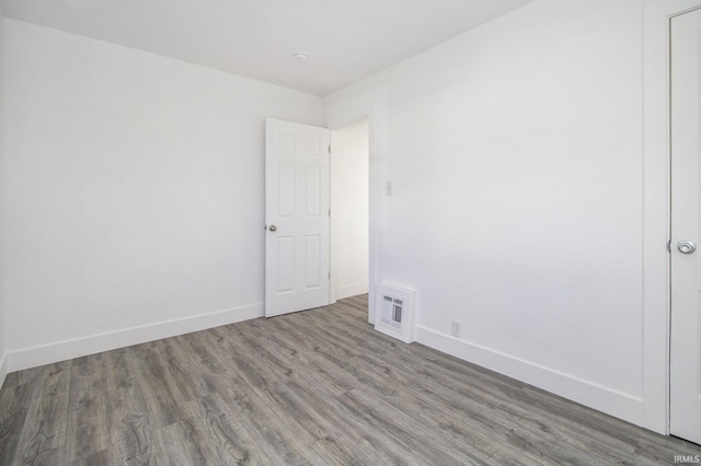 spare room with hardwood / wood-style flooring