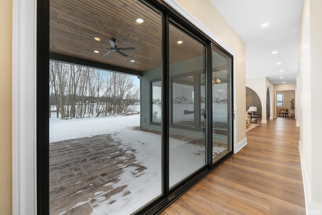 doorway with wood ceiling, ceiling fan, and hardwood / wood-style floors