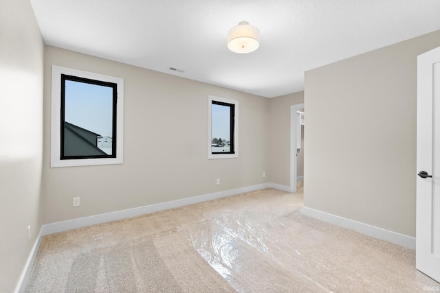 empty room with light colored carpet