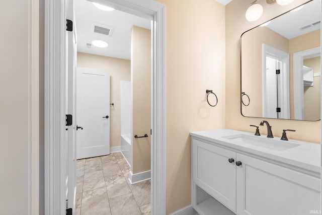 bathroom with vanity and a bath