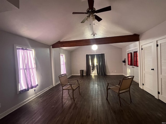 sitting room with ceiling fan, a wealth of natural light, dark hardwood / wood-style floors, and lofted ceiling with beams