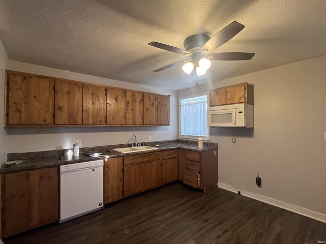 kitchen with white appliances, a textured ceiling, sink, dark hardwood / wood-style floors, and ceiling fan