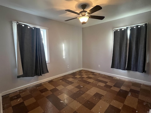 unfurnished room with ceiling fan