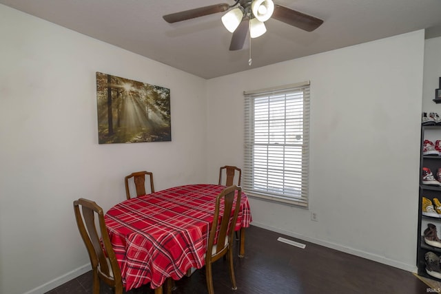 dining space featuring ceiling fan and dark wood-type flooring