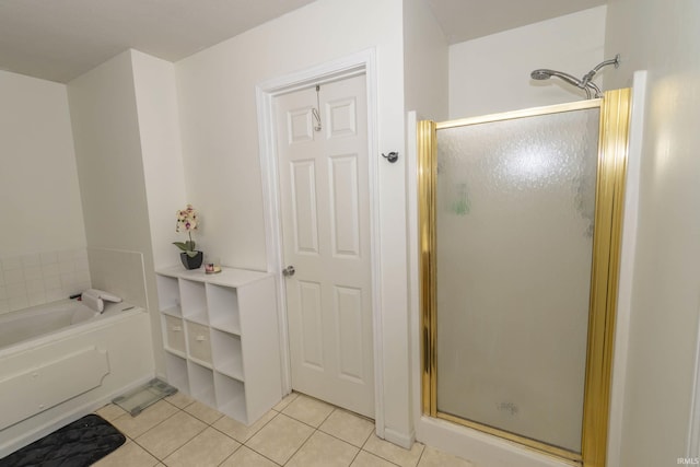 bathroom featuring tile patterned floors and separate shower and tub