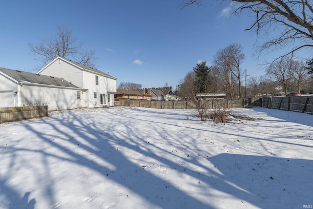 view of yard layered in snow