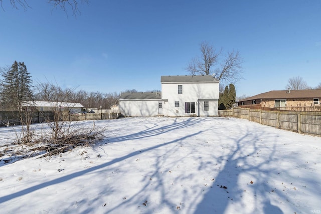 view of snow covered rear of property