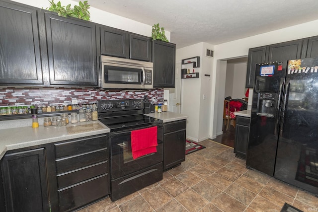 kitchen featuring black appliances, backsplash, and a textured ceiling