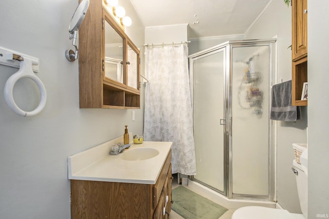 bathroom featuring vanity, toilet, a shower, and crown molding