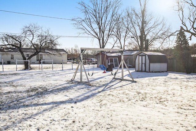 yard covered in snow with a shed