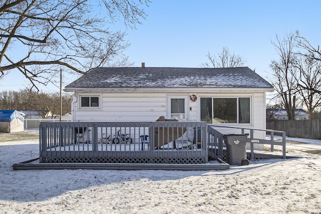 rear view of property with a wooden deck