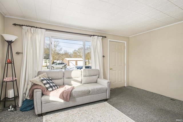 carpeted living room featuring ornamental molding