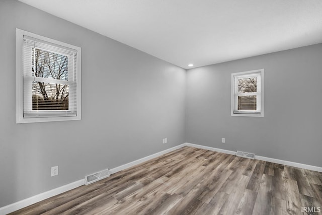 unfurnished room with wood-type flooring