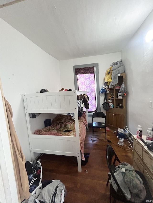 bedroom with dark hardwood / wood-style flooring