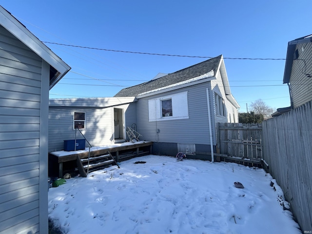 view of snow covered rear of property