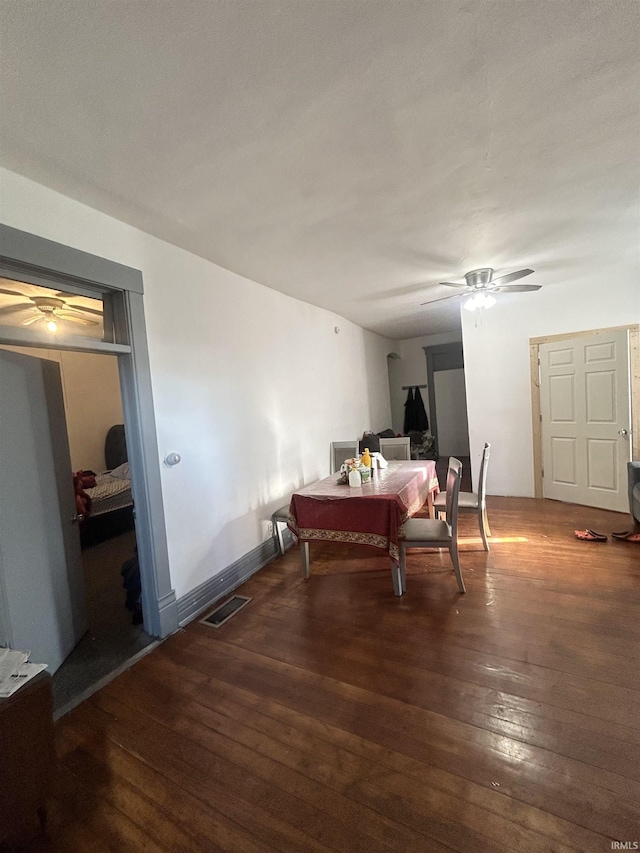 dining area with ceiling fan and dark hardwood / wood-style flooring